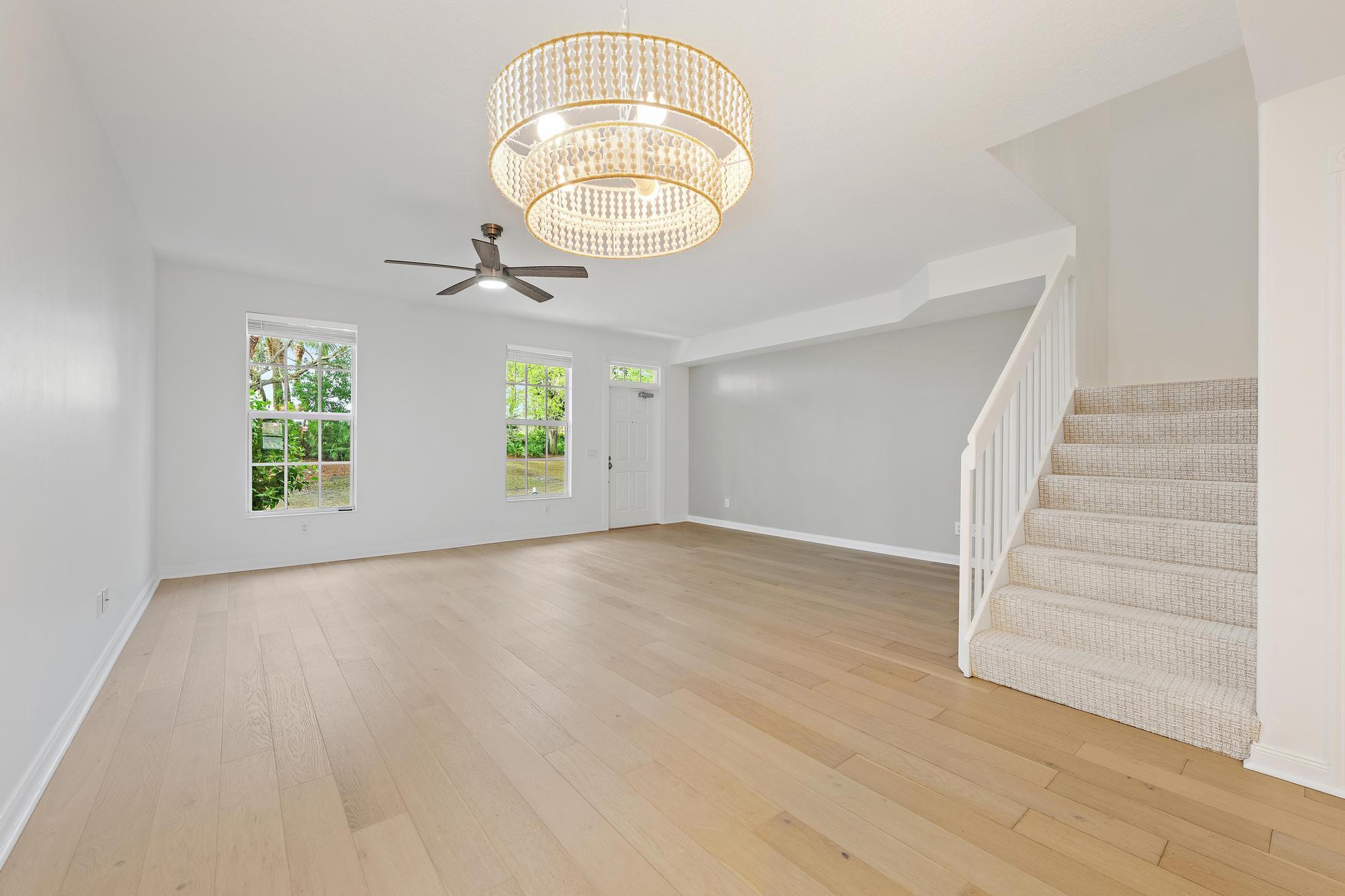 136 Ashley Court Jupiter, FL 33458 - Photo 4 of 26 an empty room with wooden floor and windows