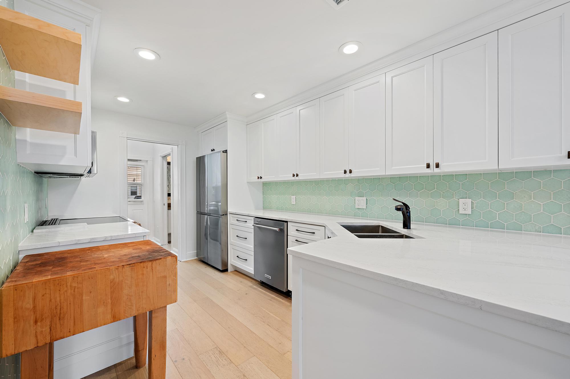 136 Ashley Court Jupiter, FL 33458 - Photo 7 of 26 a kitchen with stainless steel appliances granite countertop a sink stove and refrigerator