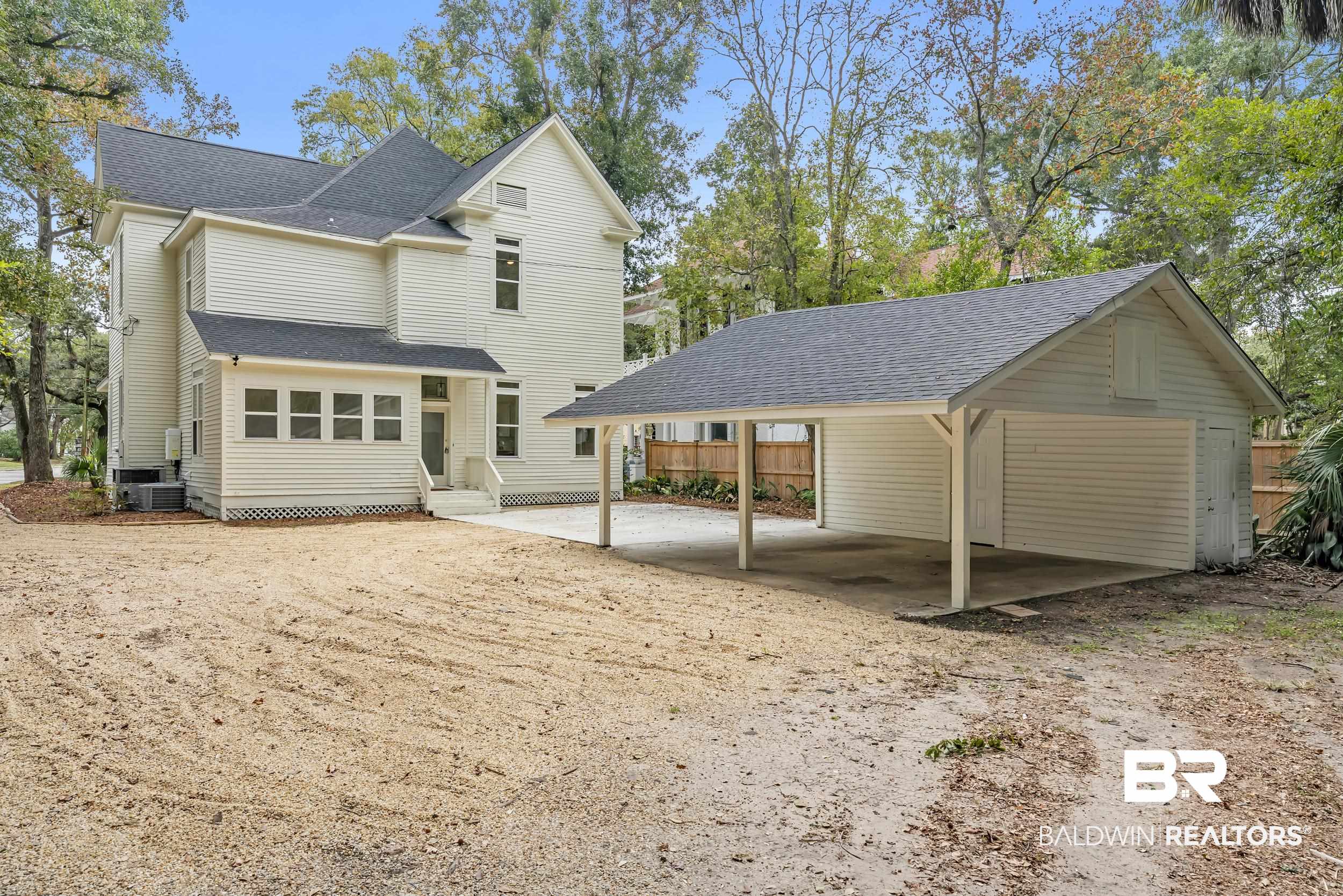 1662 Government Street Mobile, AL 36604 - Photo 33 of 33 Rear view of property featuring a shingled roof, a carport, and a patio