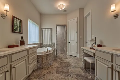 a bathroom with a tub and shower