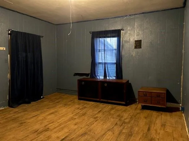 a bedroom with a bed window and dresser