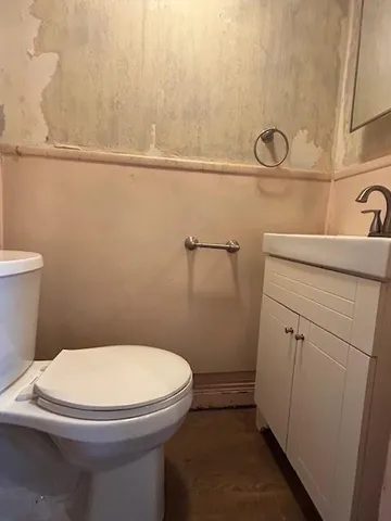 a white toilet sitting next to a bathroom sink