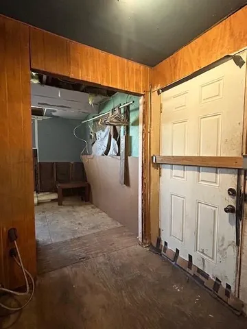 a view of a room with wooden walls and windows