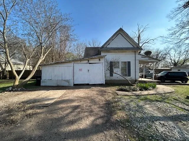 a front view of a house with a yard covered with snow in front of house