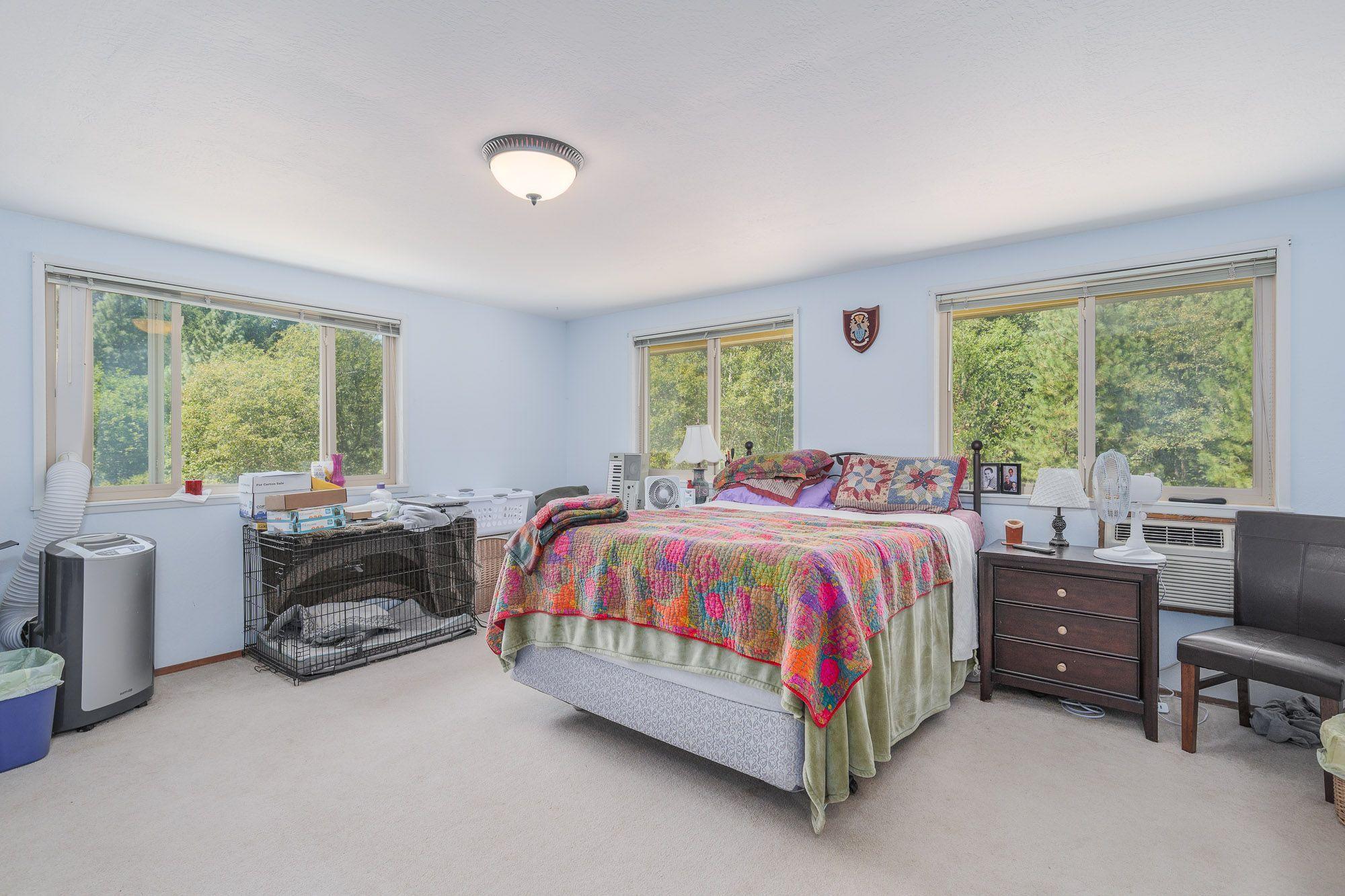 9266 Lower River Road Grants Pass, OR 97526 - Photo 26 of 39 a spacious bedroom with a bed and a large window