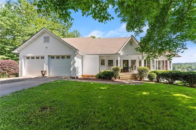a front view of a house with a yard and porch