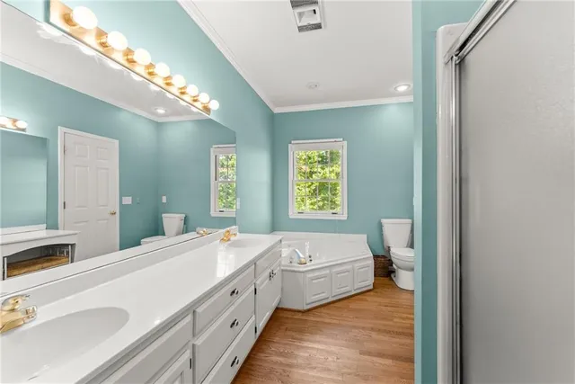 a bathroom with a double vanity sink mirror and shower