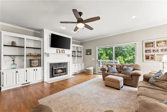 a living room with furniture wooden floor and window