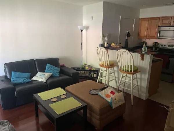 a living room with furniture and wooden floor