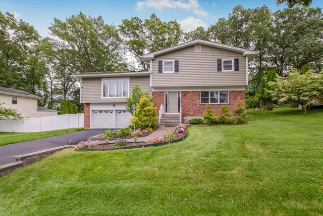 a front view of a house with a yard and garage