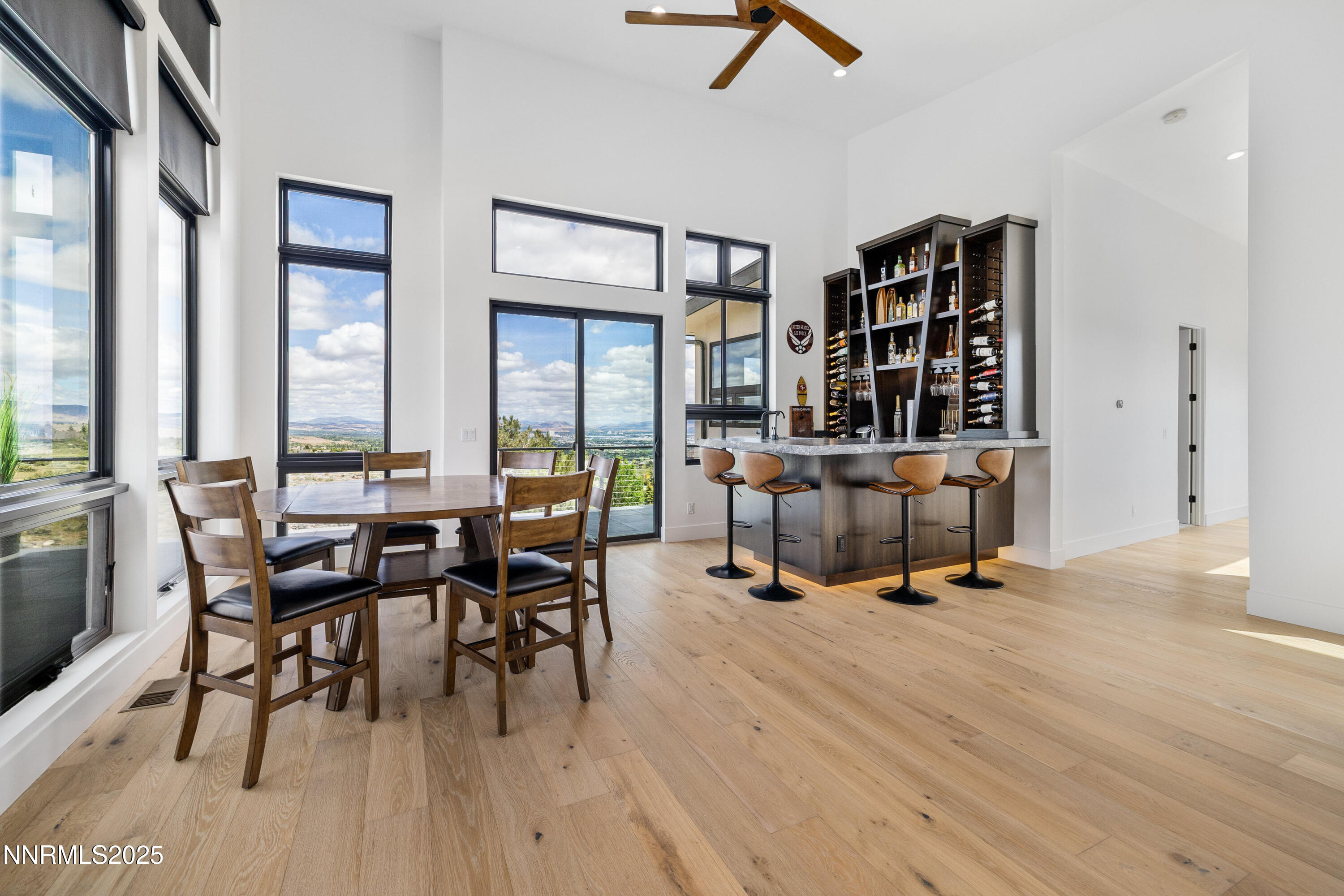 3041 Palmer Pointe Court Reno, NV 89511 - Photo 25 of 40 a view of a livingroom and a dining room with furniture window and wooden floor