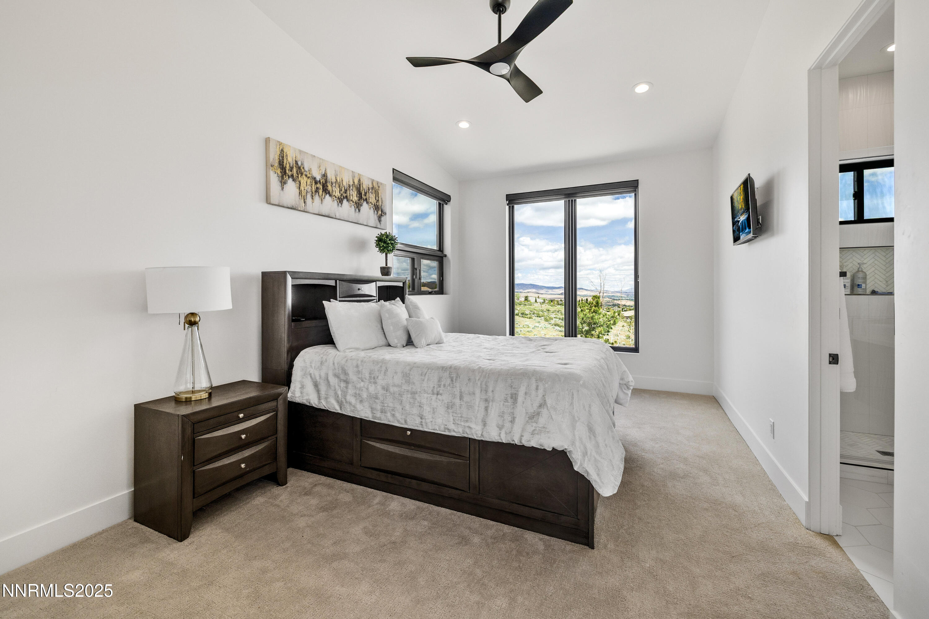 3041 Palmer Pointe Court Reno, NV 89511 - Photo 31 of 40 a bedroom with a bed and a chandelier