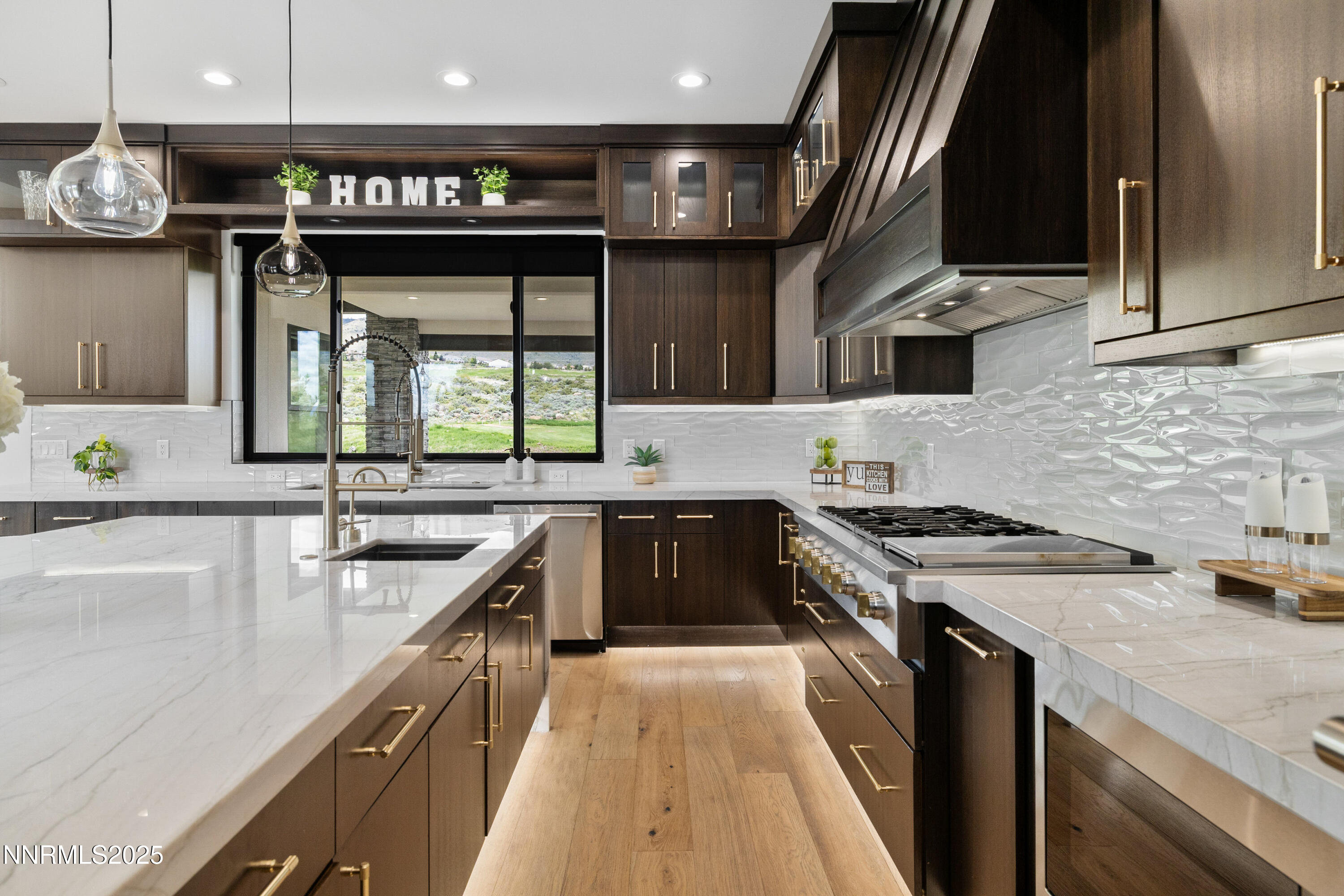 3041 Palmer Pointe Court Reno, NV 89511 - Photo 7 of 40 a kitchen with kitchen island granite countertop a sink stove and cabinets