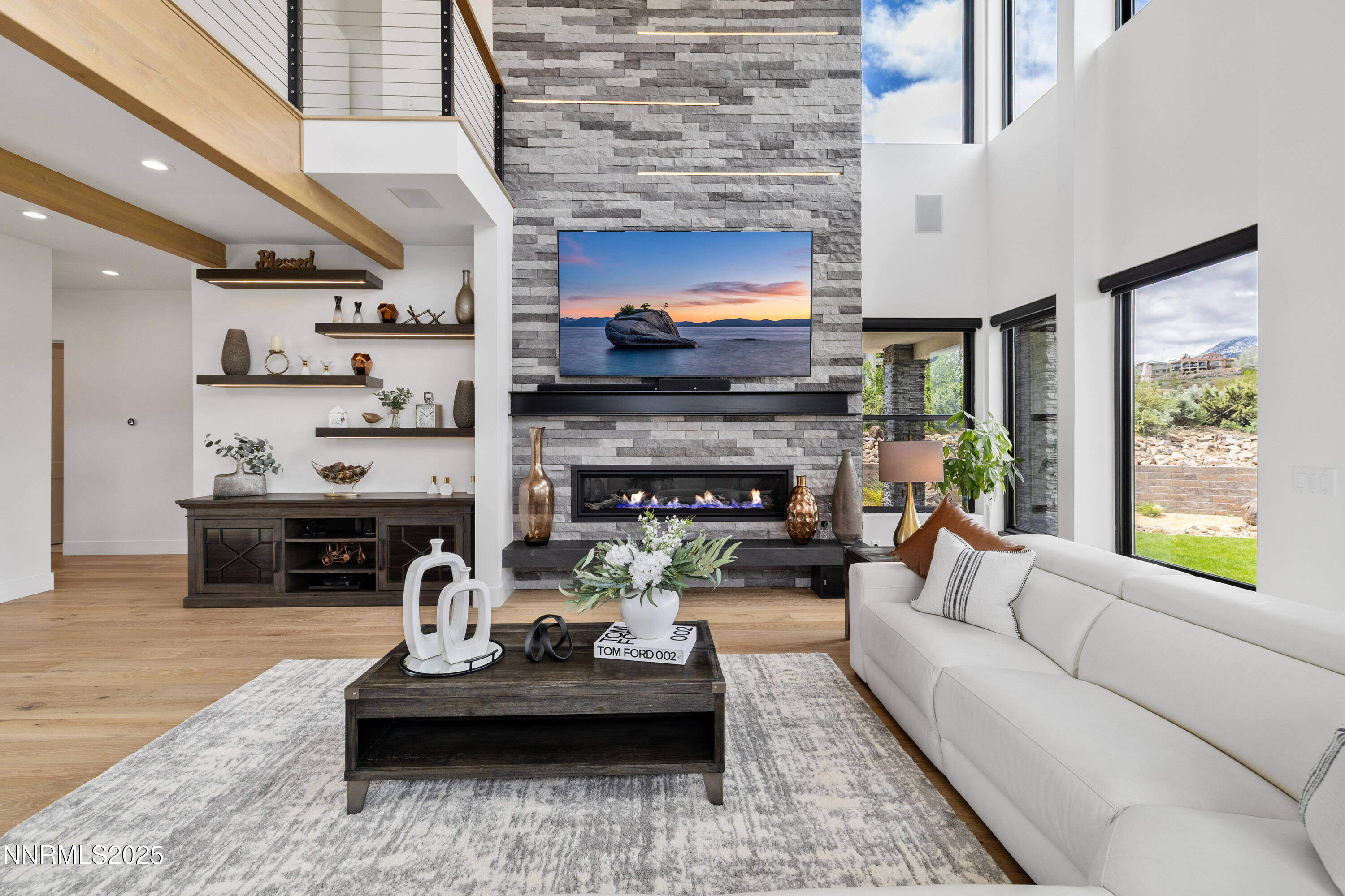 3041 Palmer Pointe Court Reno, NV 89511 - Photo 10 of 40 a living room with furniture a fireplace and a flat screen tv
