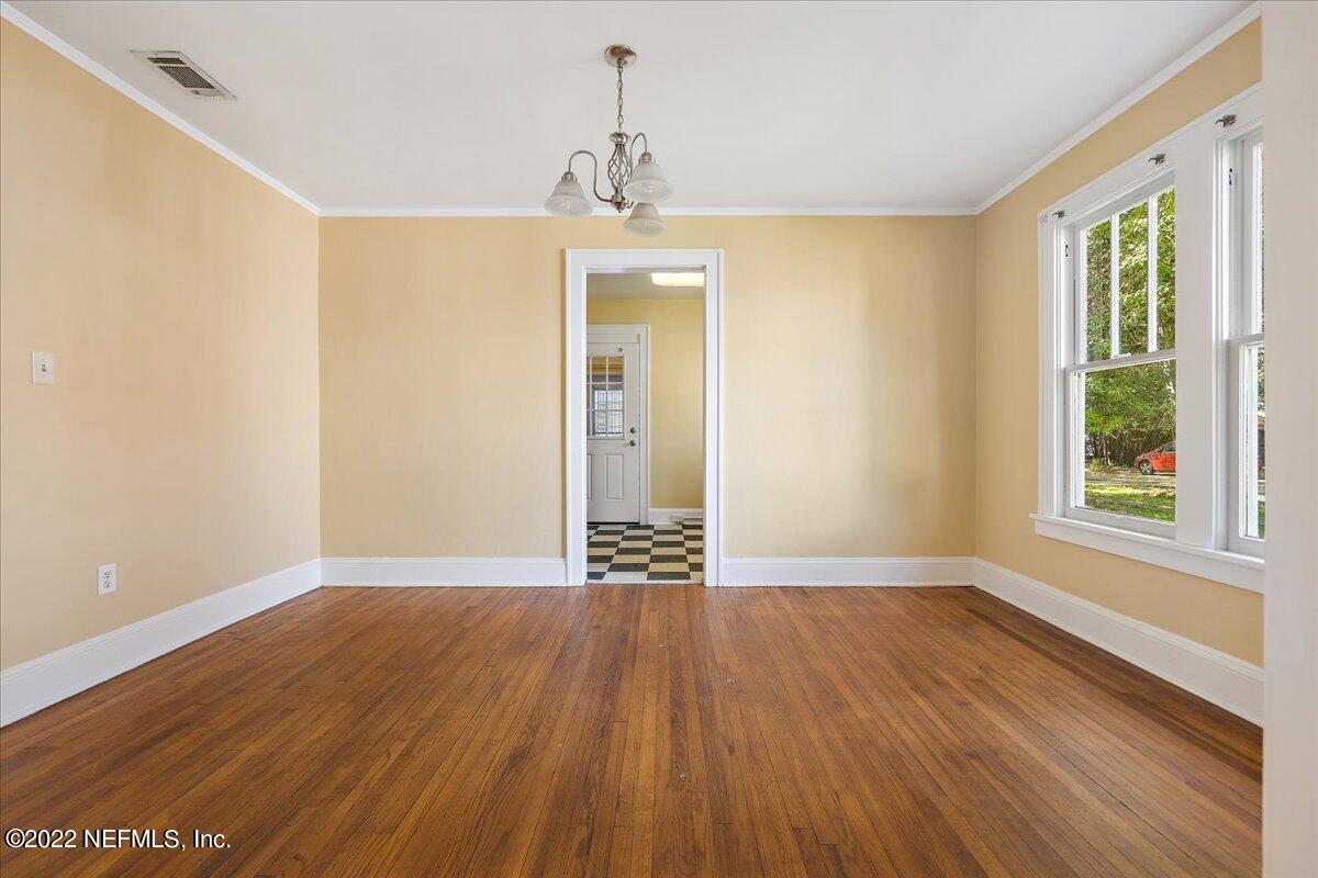 352 West 68th Street Jacksonville, FL 32208 - Photo 3 of 11 a view of an empty room with wooden floor and a window