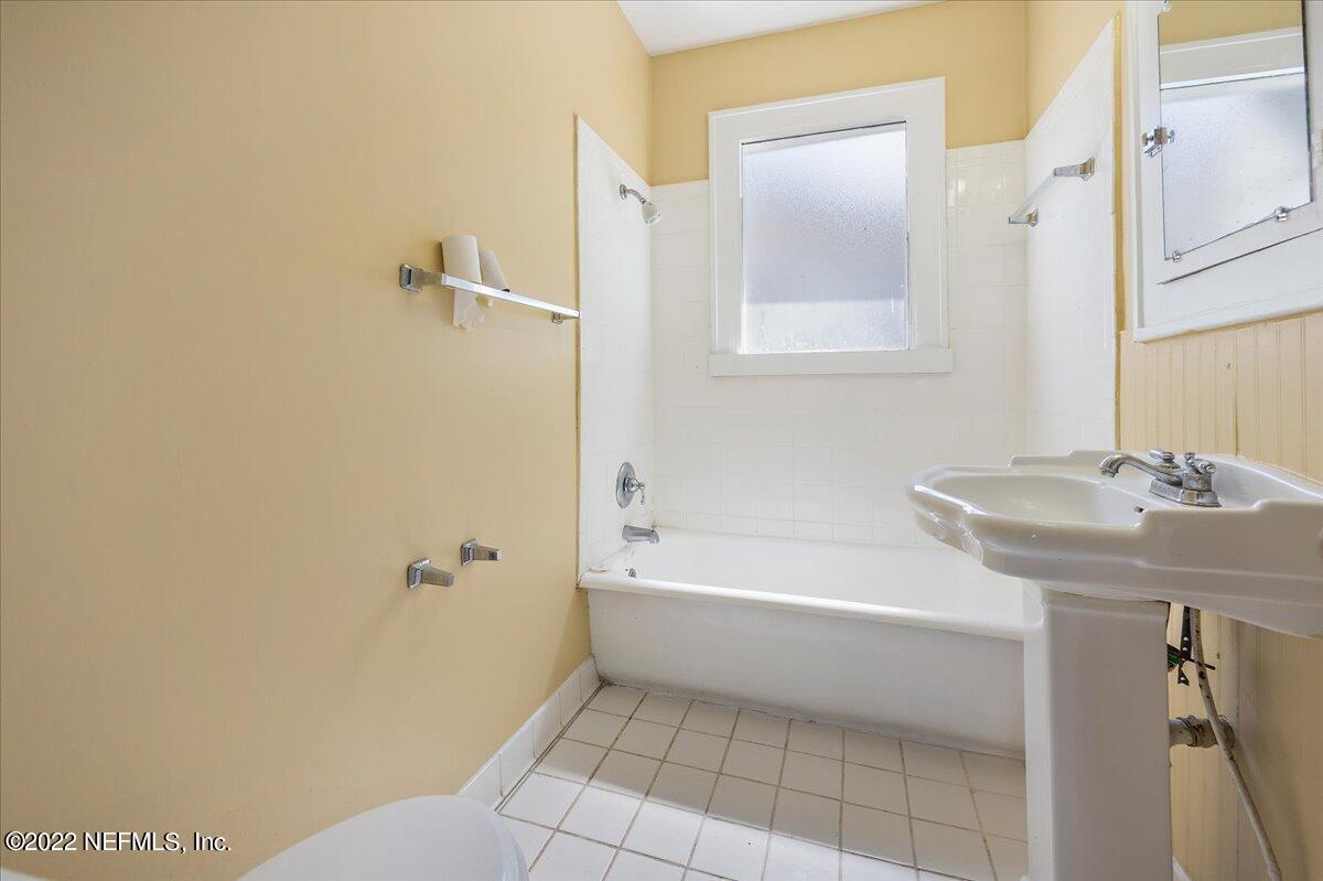 352 West 68th Street Jacksonville, FL 32208 - Photo 9 of 11 a bathroom with a sink a toilet and shower