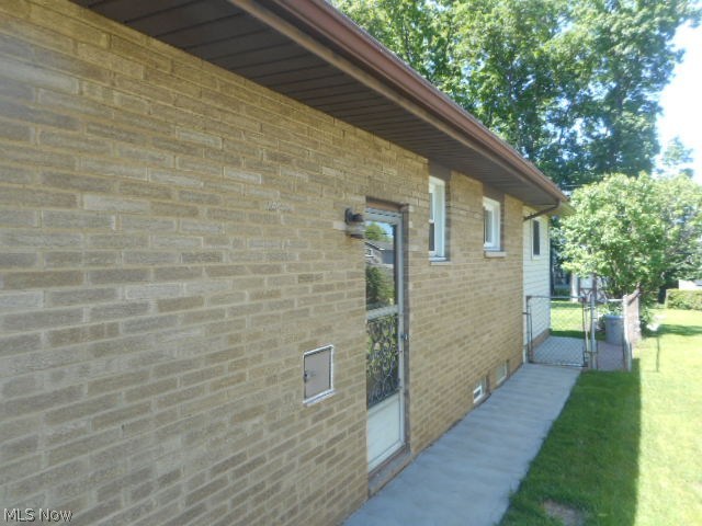 8560 Royal Ridge Drive Parma, OH 44129 - Photo 4 of 21 The east side of the house. Notice the mint private walkway, garage service door, exterior lighting, and gate to the fenced-in backyard.