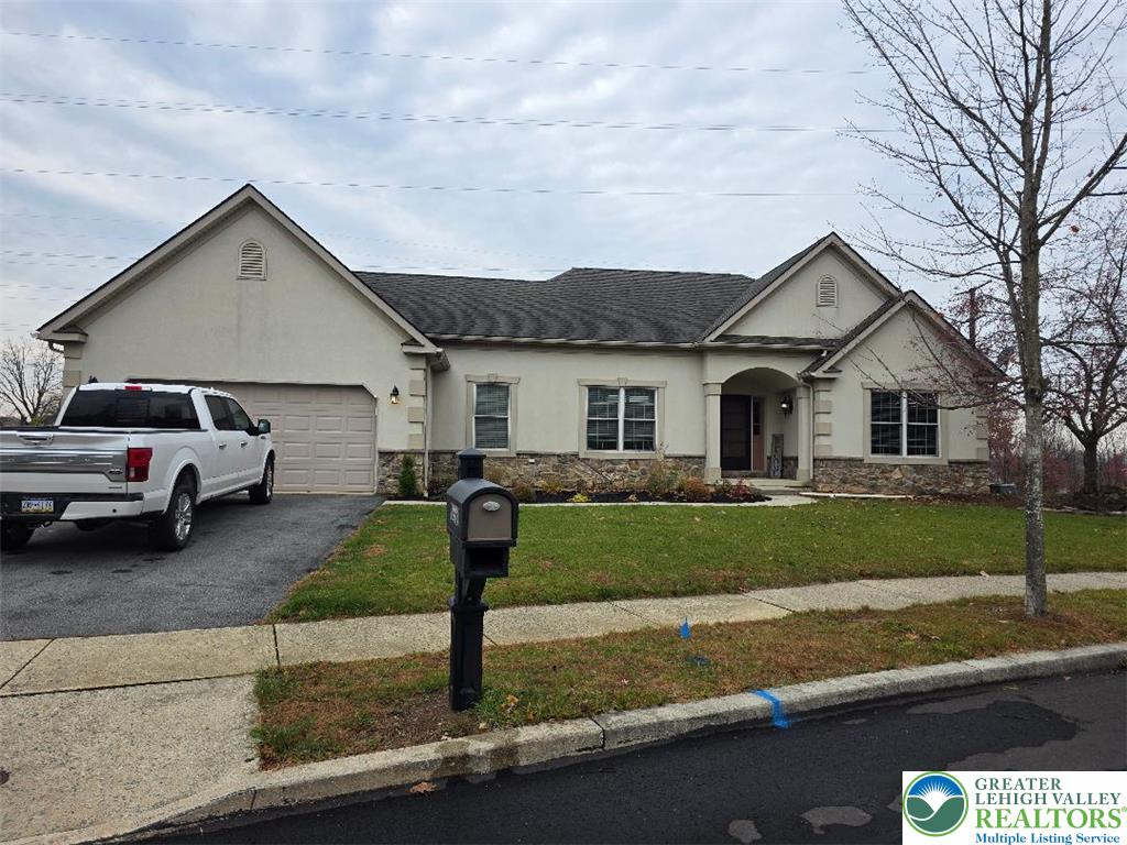 1206 Shiloh Road Lower Macungie Township, PA 18106 - Photo 1 of 14 a front view of a house with a yard and garage