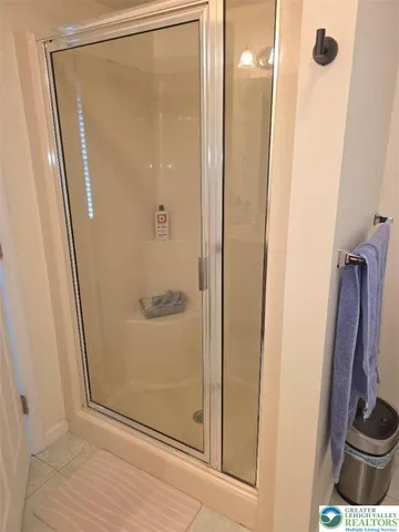 a bathroom with a shower and a mirror