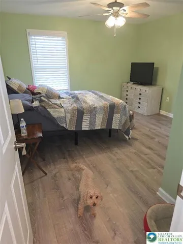 a bedroom with a bed and a chandelier