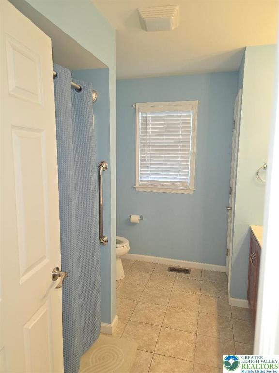 1206 Shiloh Road Lower Macungie Township, PA 18106 - Photo 10 of 14 a bathroom with a granite countertop sink a toilet and a mirror