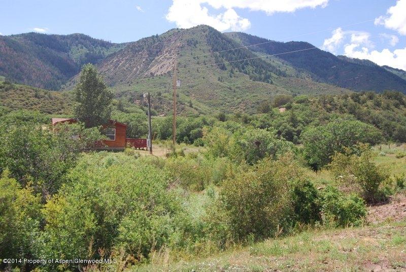8175 County Road 252 Rifle, CO 81650 - Photo 18 of 39 a view of a mountain range with lush green forest