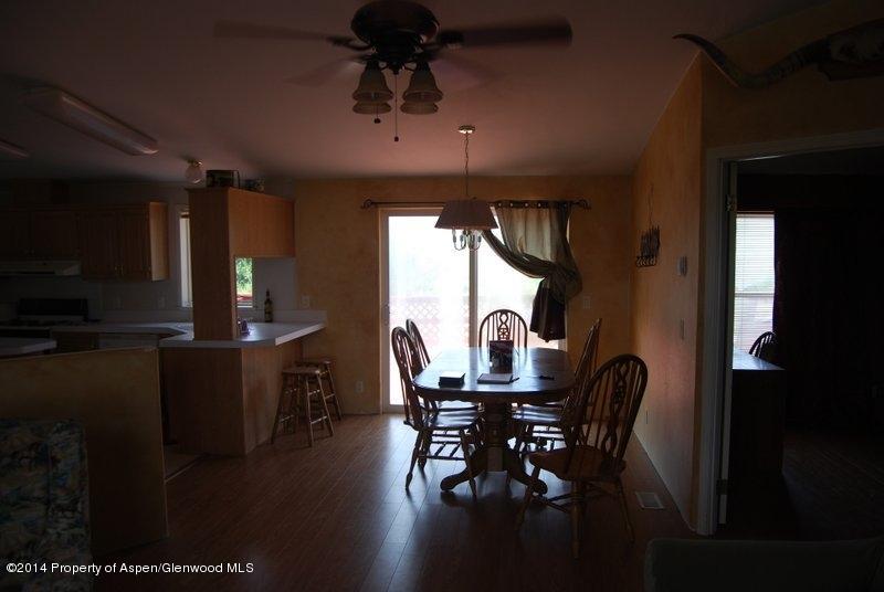 8175 County Road 252 Rifle, CO 81650 - Photo 25 of 39 a dining room with furniture window and wooden floor
