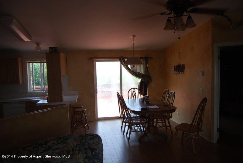 8175 County Road 252 Rifle, CO 81650 - Photo 26 of 39 a view of a dining room with furniture window and wooden floor