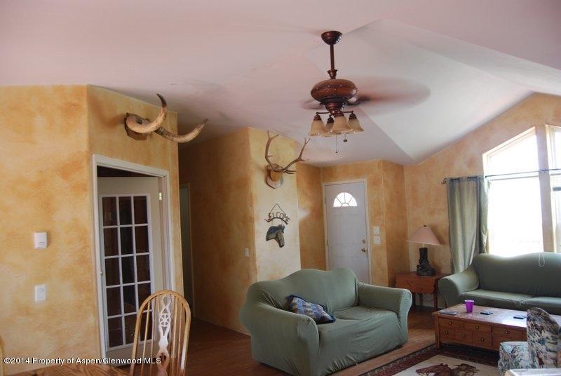 8175 County Road 252 Rifle, CO 81650 - Photo 27 of 39 a living room with furniture and a chandelier