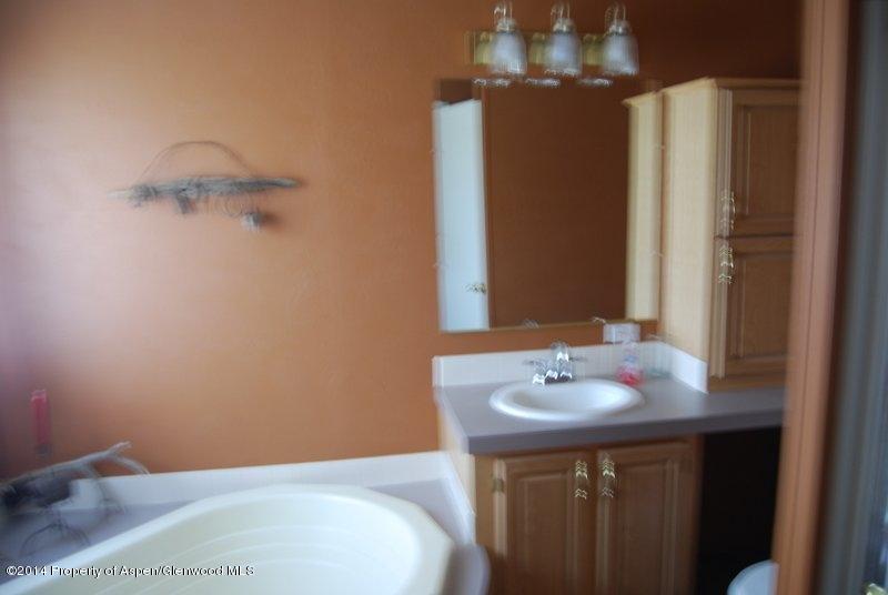 8175 County Road 252 Rifle, CO 81650 - Photo 29 of 39 a bathroom with a sink and a mirror