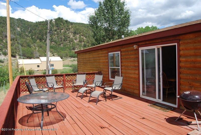 8175 County Road 252 Rifle, CO 81650 - Photo 30 of 39 a view of balcony with couch and wooden floor