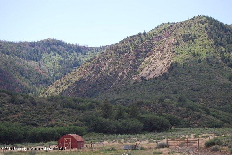 8175 County Road 252 Rifle, CO 81650 - Photo 31 of 39 a view of a dry yard with mountains in the background