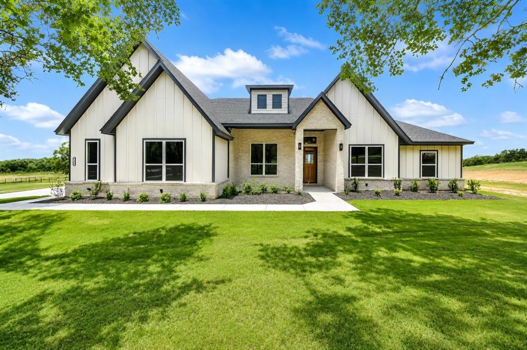 a front view of house with yard and green space