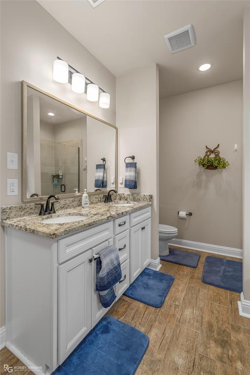 122 Brimestone Loop Benton, LA 71006 - Photo 17 of 33 a spacious bathroom with a granite countertop sink a toilet and a mirror
