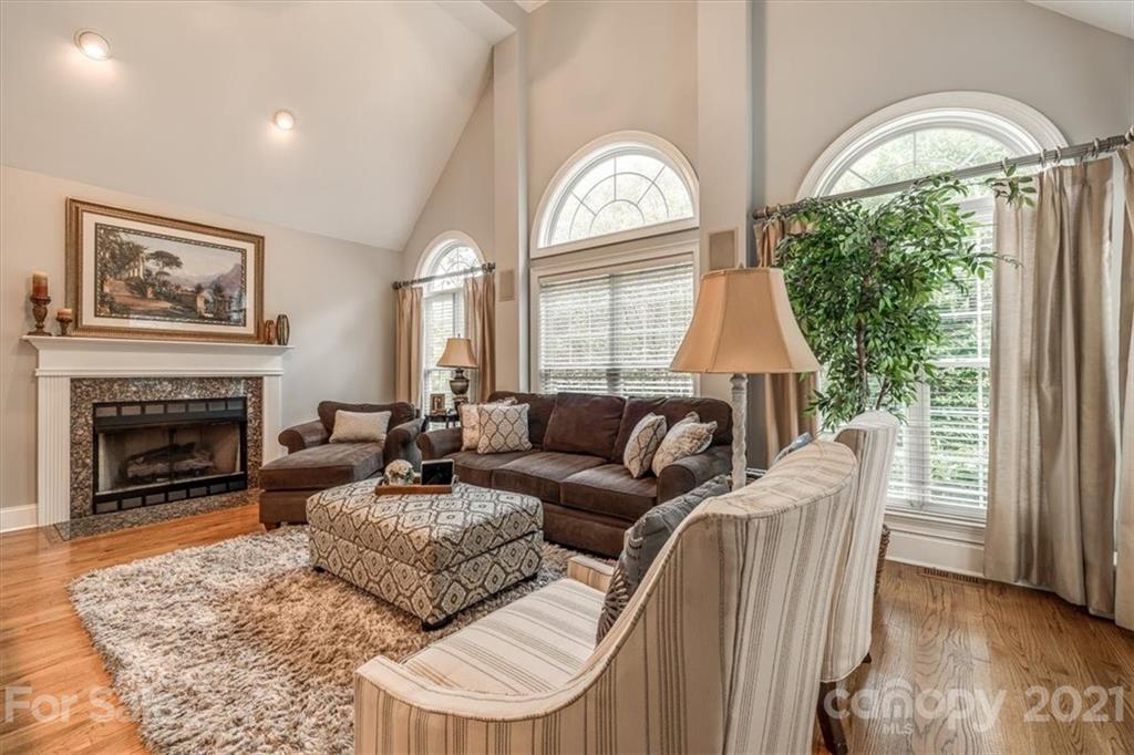 904 Ashford Way Fort Mill, SC 29708 - Photo 14 of 48 a living room with furniture a fireplace and a large window