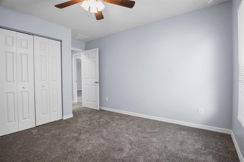 4078 Oak Loop Mulberry, FL 33860 - Photo 7 of 19 an empty room with a chandelier fan