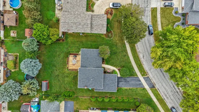 an aerial view of residential houses with outdoor space and parking