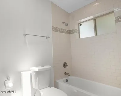 a bathroom with a toilet and shower