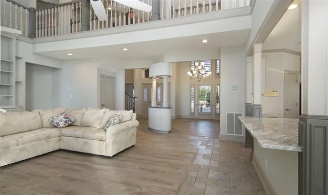 a kitchen with stainless steel appliances granite countertop white cabinets sink and large window