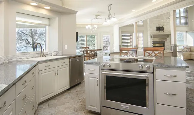 a view of empty room with wooden floor and fireplace