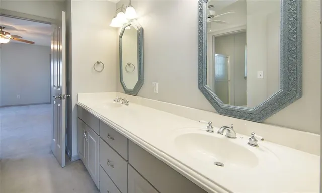 a white toilet sitting next to a bathroom sink