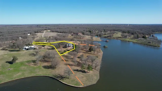 an aerial view of a house with yard and parking