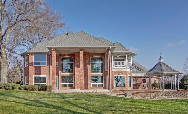 a view of a brick building next to a yard