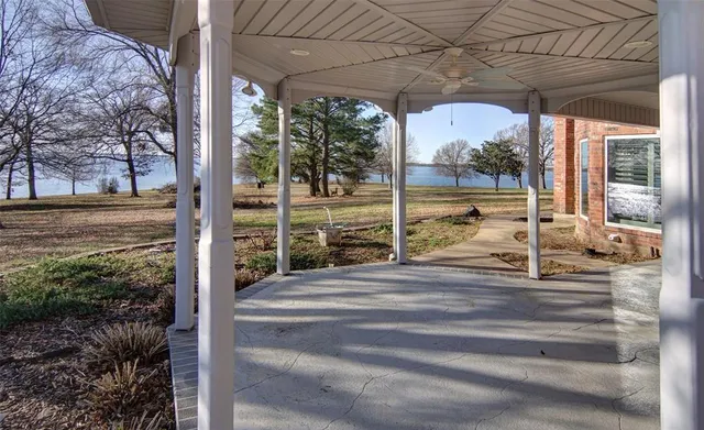 a view of empty room with wooden floor and window