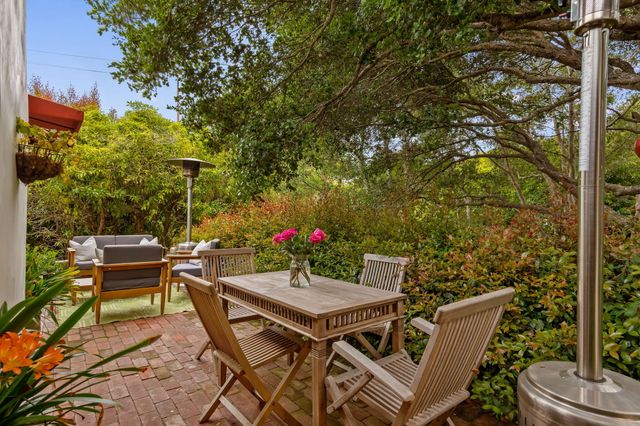 a view of a patio with table and chairs and potted plants