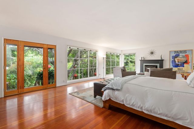 a large bedroom with a large bed and a large window