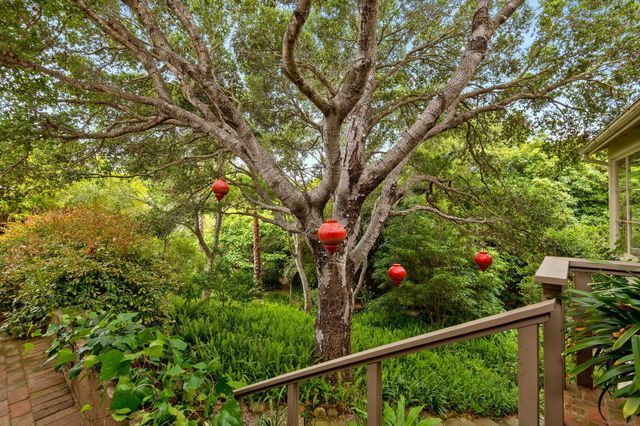 a view of a house with a tree in the background