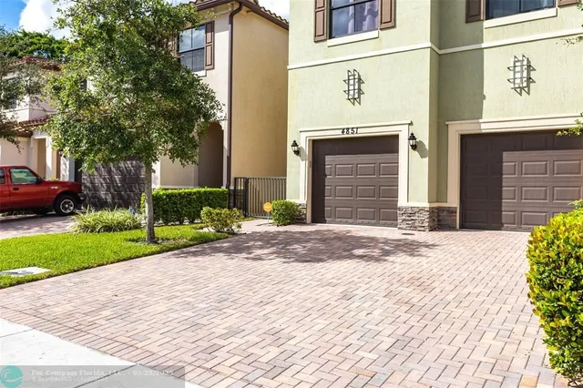 a front view of a building with garden