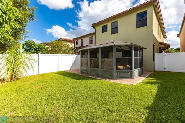 a view of a house with a yard and sitting area