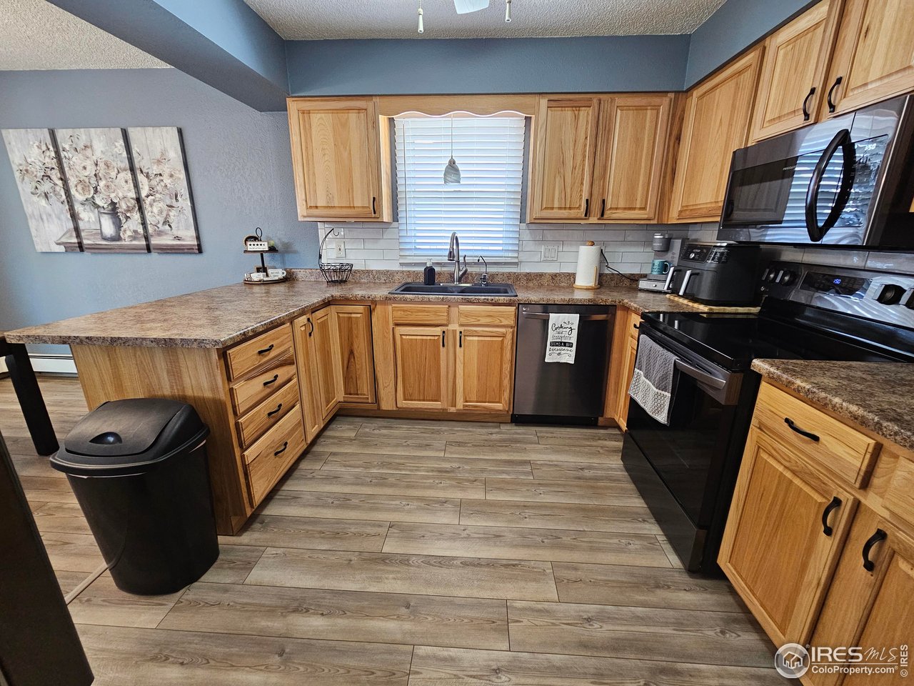 1628 Pheasant Ridge Sterling, CO 80751 - Photo 11 of 40 Kitchen view from entrance off living room near the stairs and hallway to the bedrooms